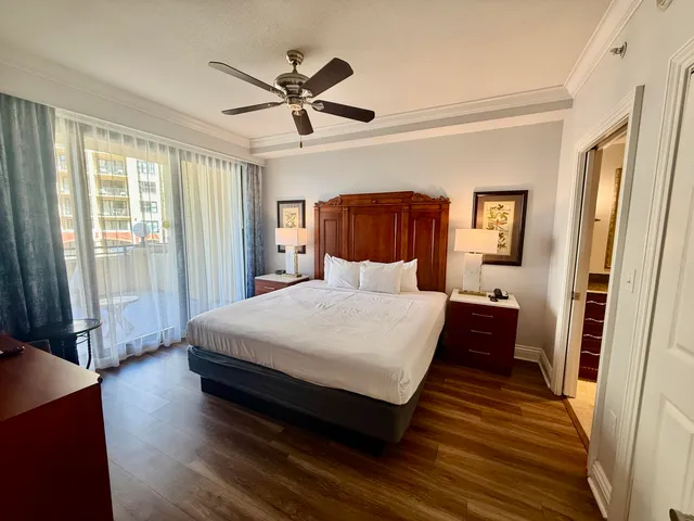 a bedroom with a large bed and a chandelier