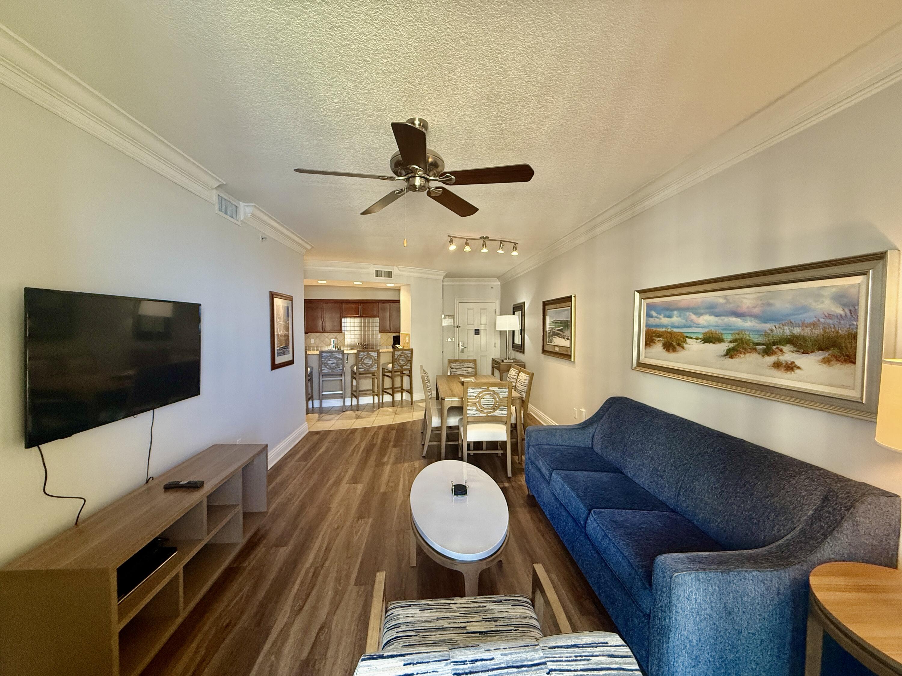 10 Harbor Boulevard, Unit E803G Destin, FL 32541 - Photo 3 of 28 a living room with furniture and a flat screen tv