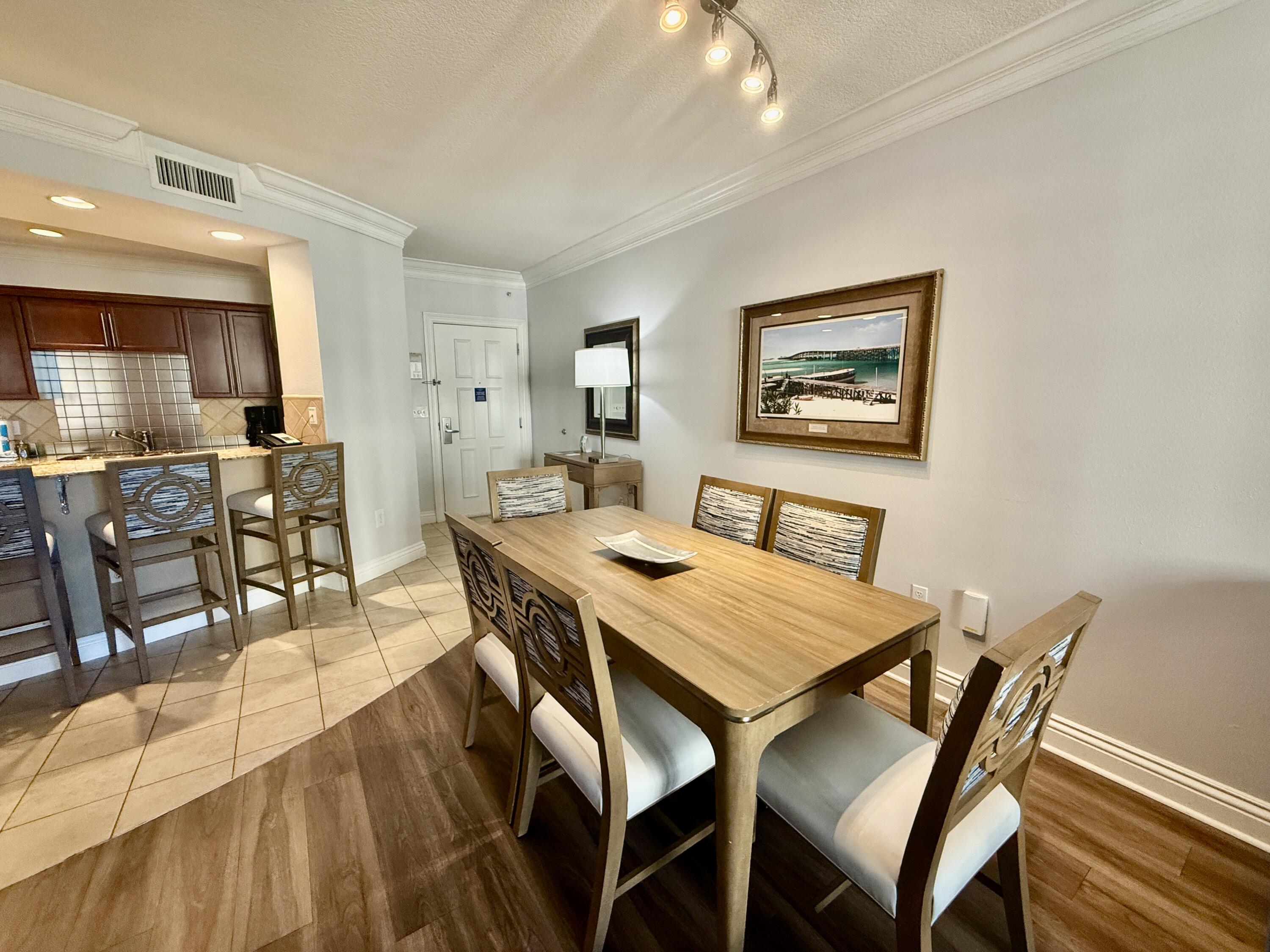 10 Harbor Boulevard, Unit E803G Destin, FL 32541 - Photo 4 of 28 a view of a dining room with furniture and wooden floor