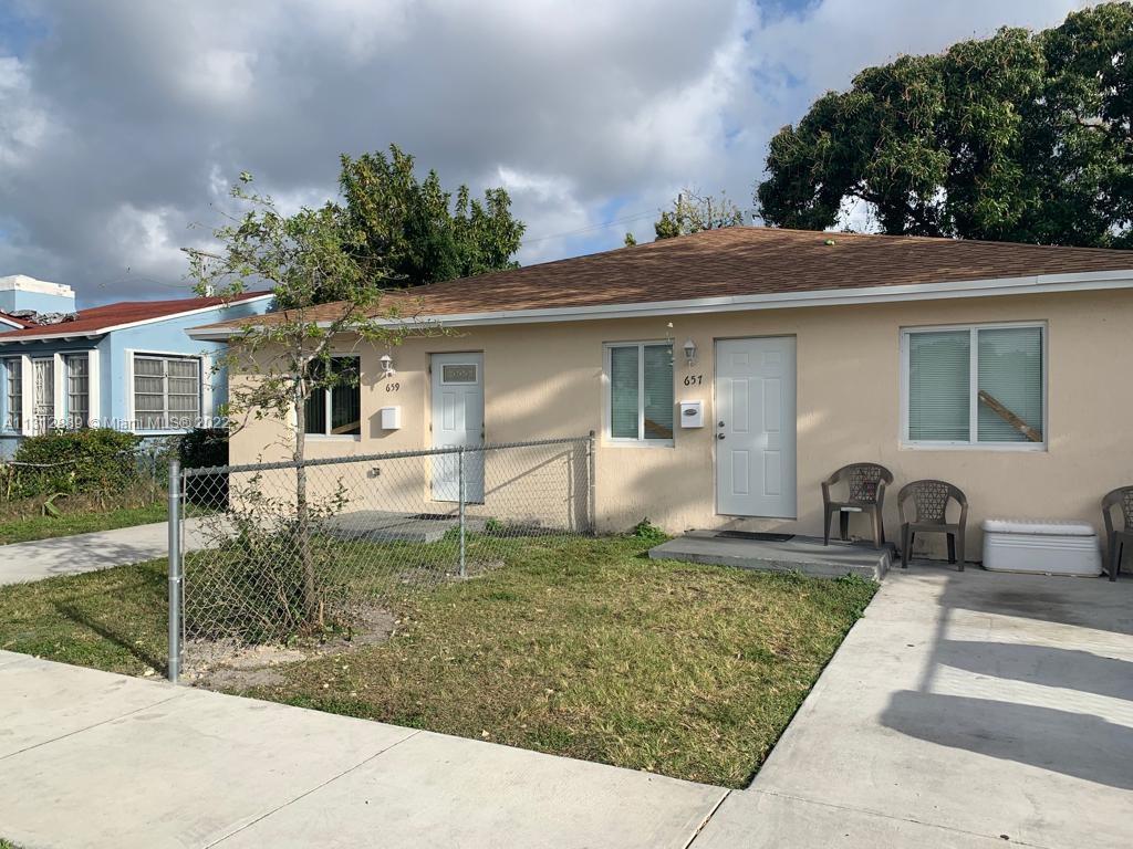 659 Northwest 47th Street, Unit 659 Miami, FL 33127 - Photo 1 of 9 a front view of a house with garden