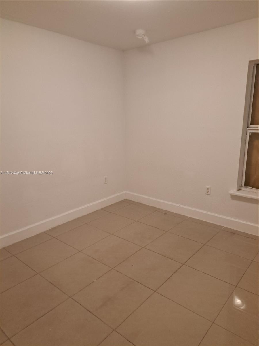 659 Northwest 47th Street, Unit 659 Miami, FL 33127 - Photo 7 of 9 a view of a room with white door