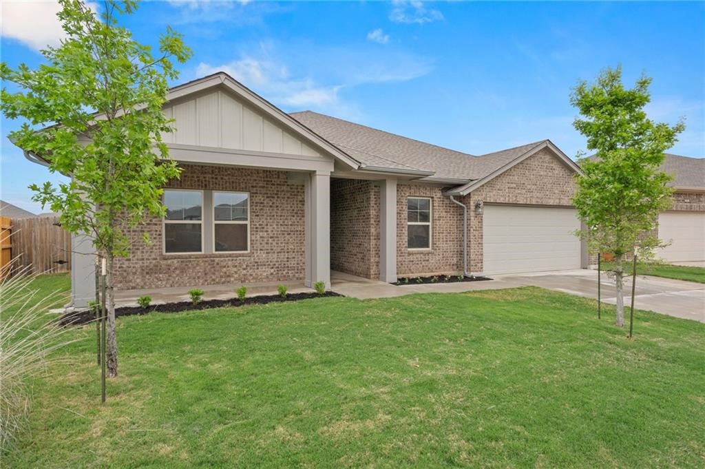 138 Edgewater Trail Bastrop, TX 78602 - Photo 1 of 1 a front view of a house with a yard