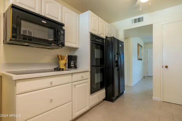 a kitchen with stainless steel appliances a refrigerator stove and microwave