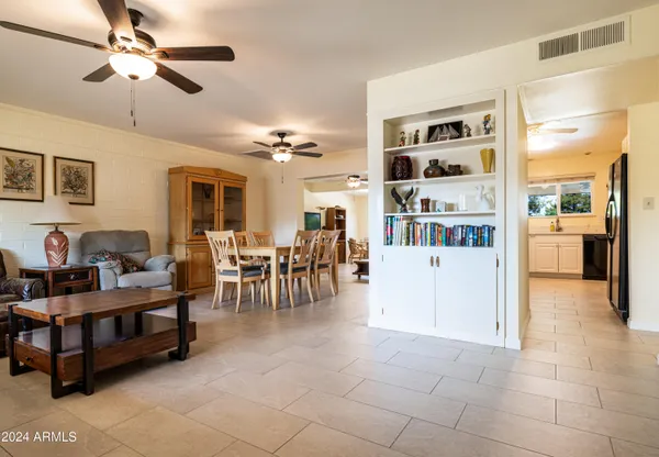 a living room with furniture and chandelier
