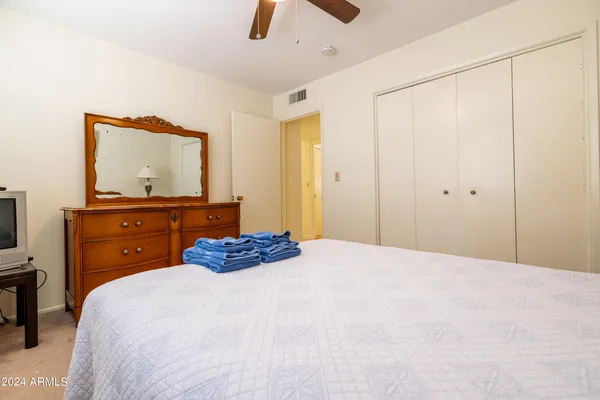 a bedroom with a bed and a dresser
