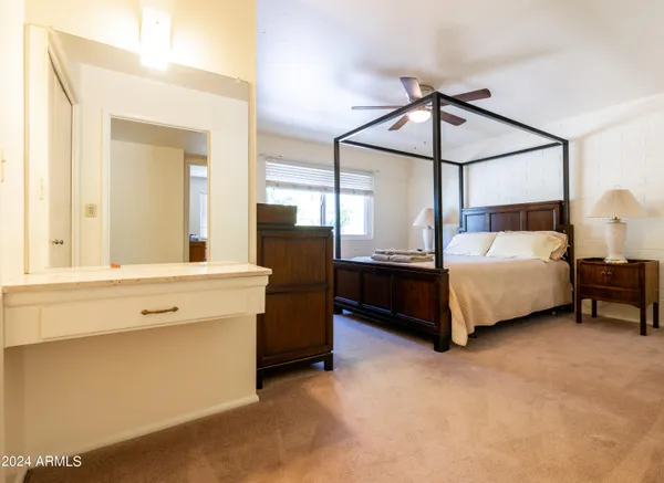 a bedroom with a bed table and window