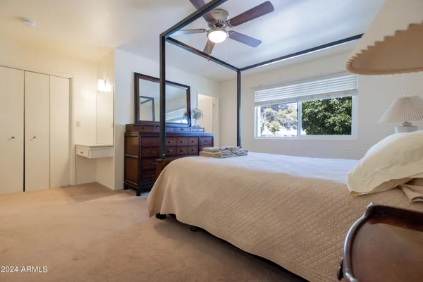 a bed room with a bed and a dresser