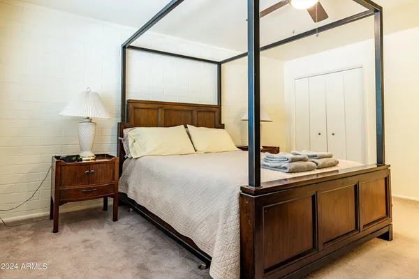 a bedroom with a bed and a table in it