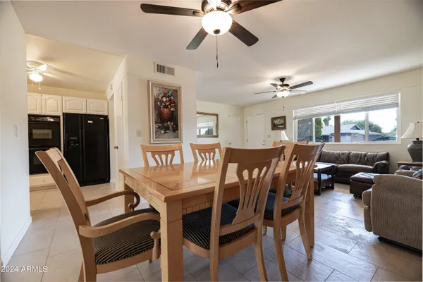 a dining room with furniture a chandelier and window