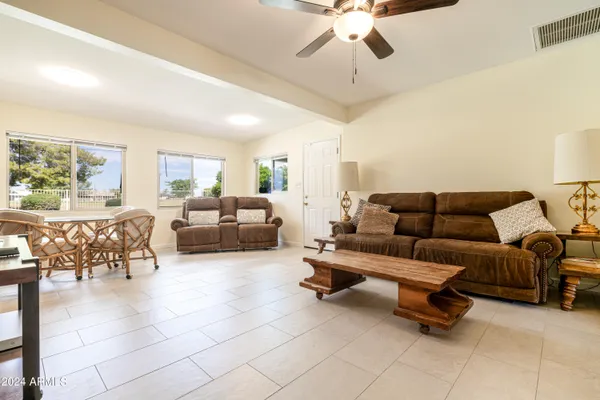 a living room with furniture and a chandelier