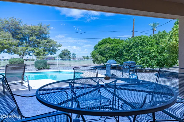 a view of a chairs and table in patio