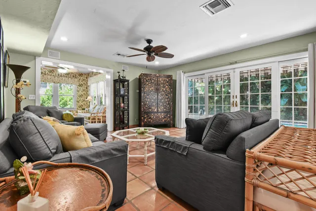 a living room with furniture and a chandelier
