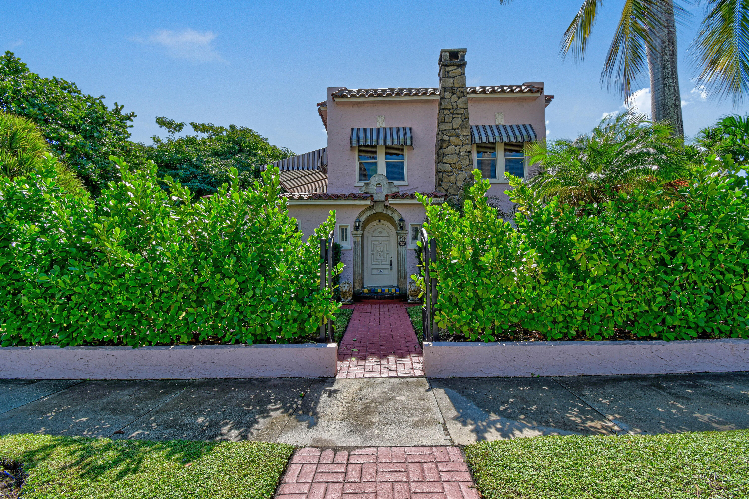 194 Almeria Road West Palm Beach, FL 33405 - Photo 2 of 67 a front view of a house with a yard and potted plants