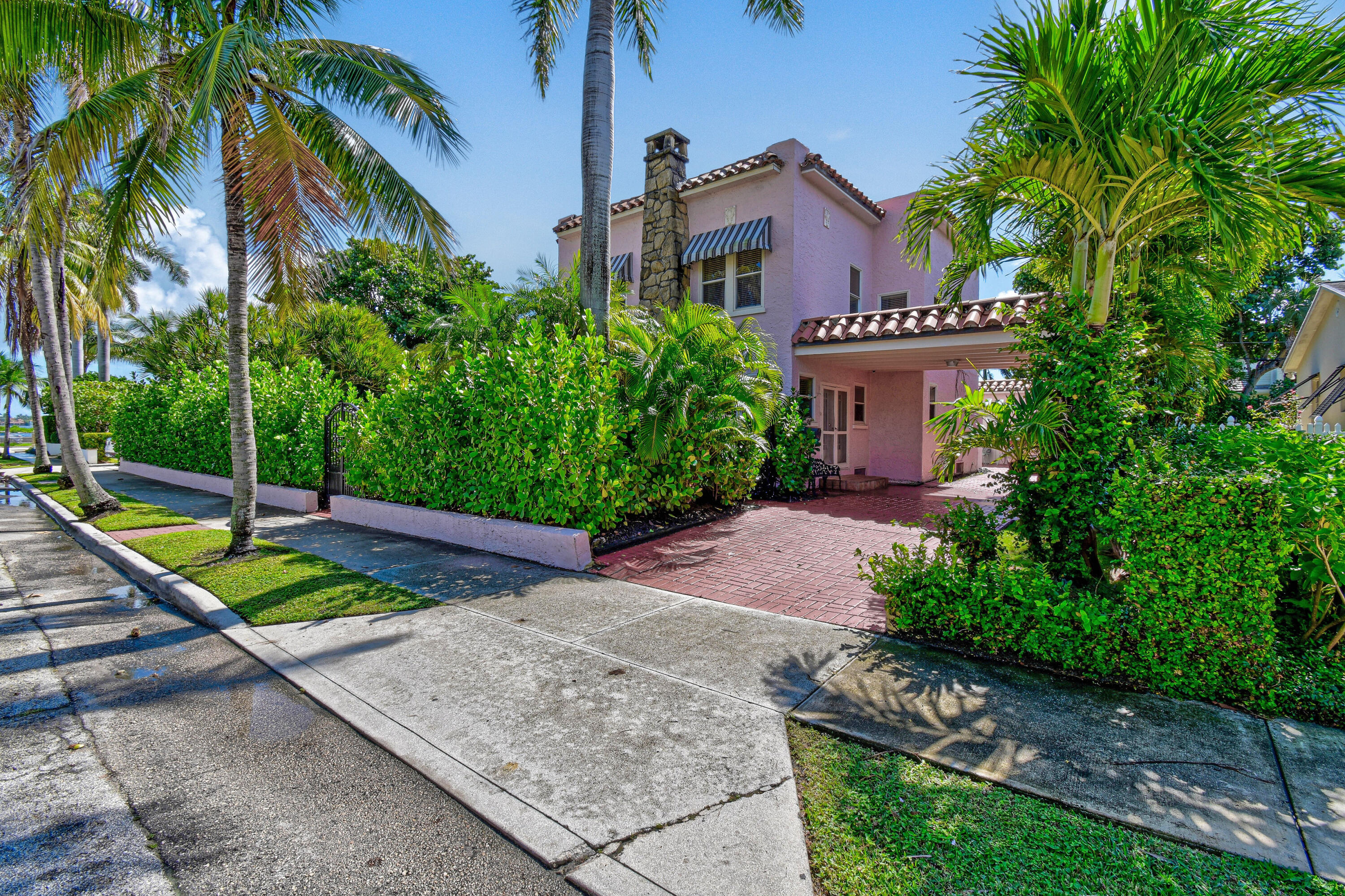 194 Almeria Road West Palm Beach, FL 33405 - Photo 3 of 67 a view of a house with a yard and potted plants