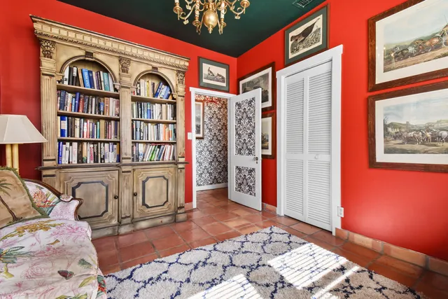 a bed sitting in a spacious bedroom next to a window