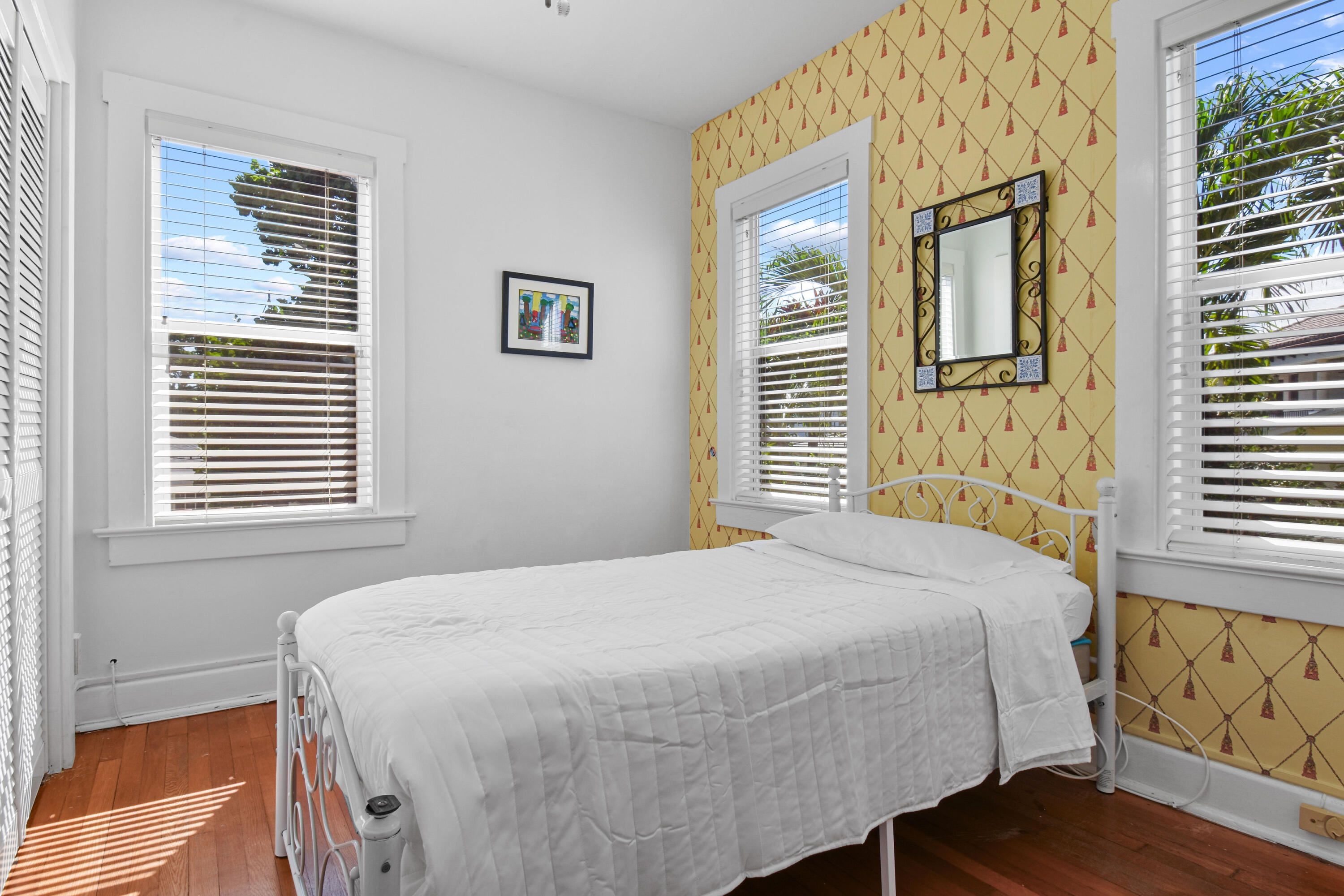 194 Almeria Road West Palm Beach, FL 33405 - Photo 43 of 67 a bedroom with a bed and a window with wooden floor