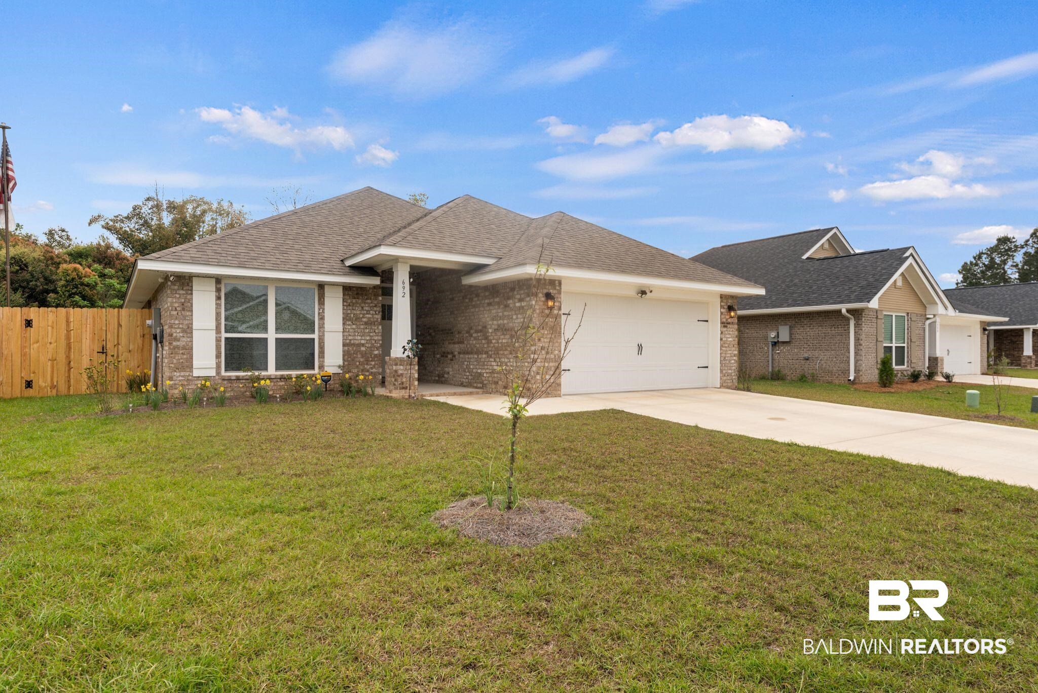 692 Mayflower Drive Foley, AL 36535 - Photo 2 of 40 Single story home with a shingled roof, a garage, a front yard, and brick siding