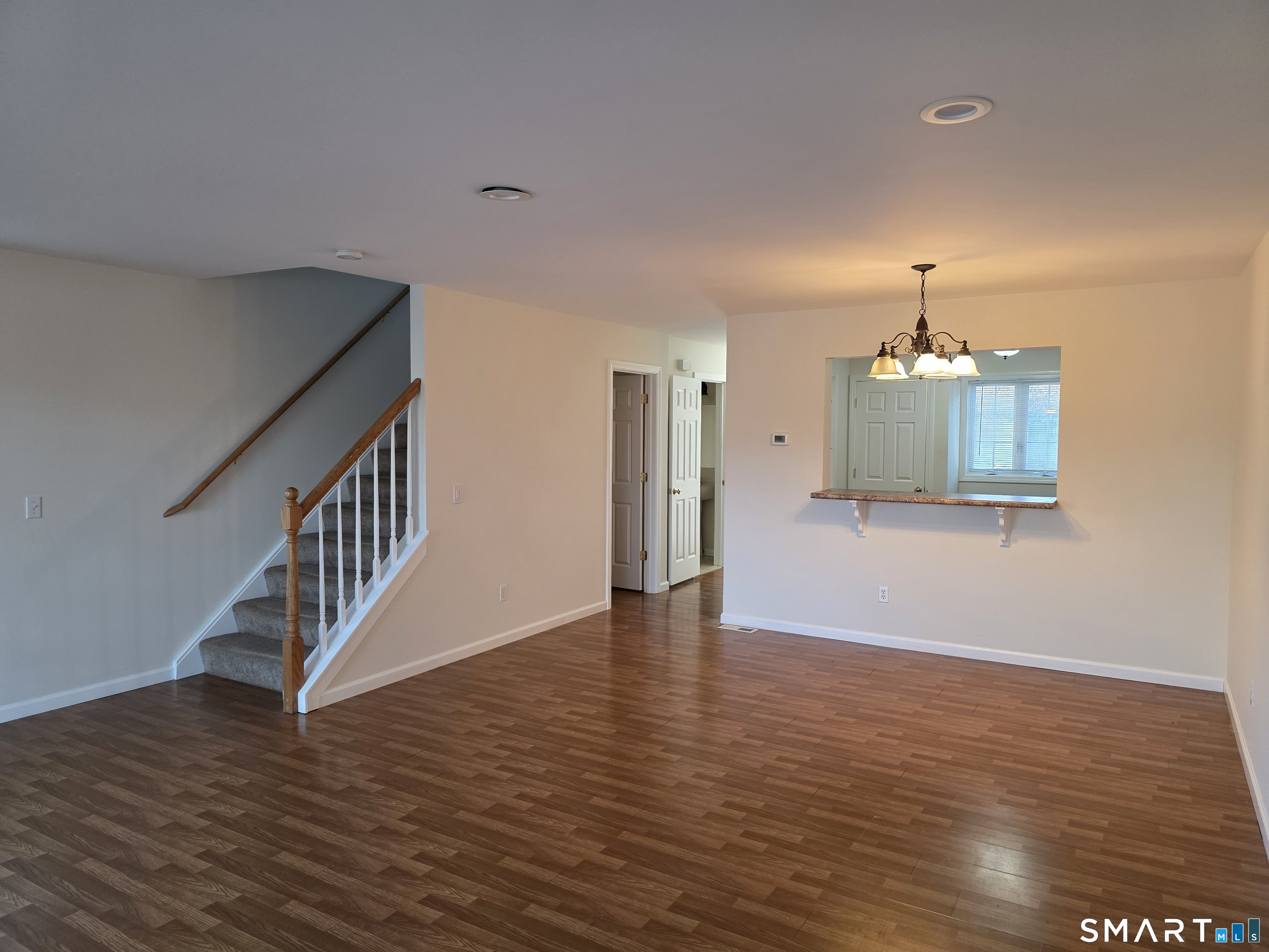 148 Mathewson Street, Unit 609 Griswold, CT 06351 - Photo 11 of 23 a view of a room with wooden floor and staircase