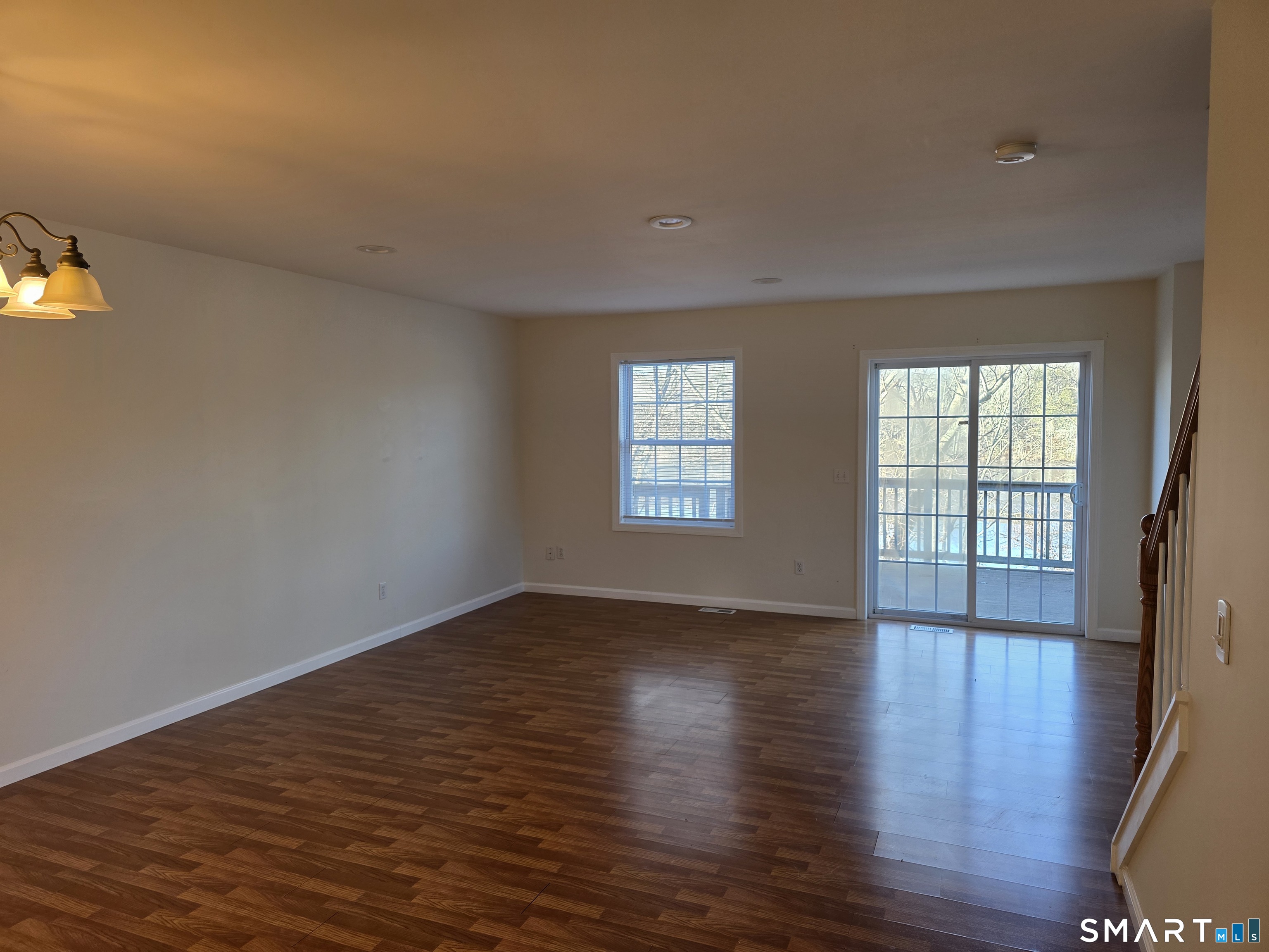 148 Mathewson Street, Unit 609 Griswold, CT 06351 - Photo 22 of 23 an empty room with wooden floor and windows