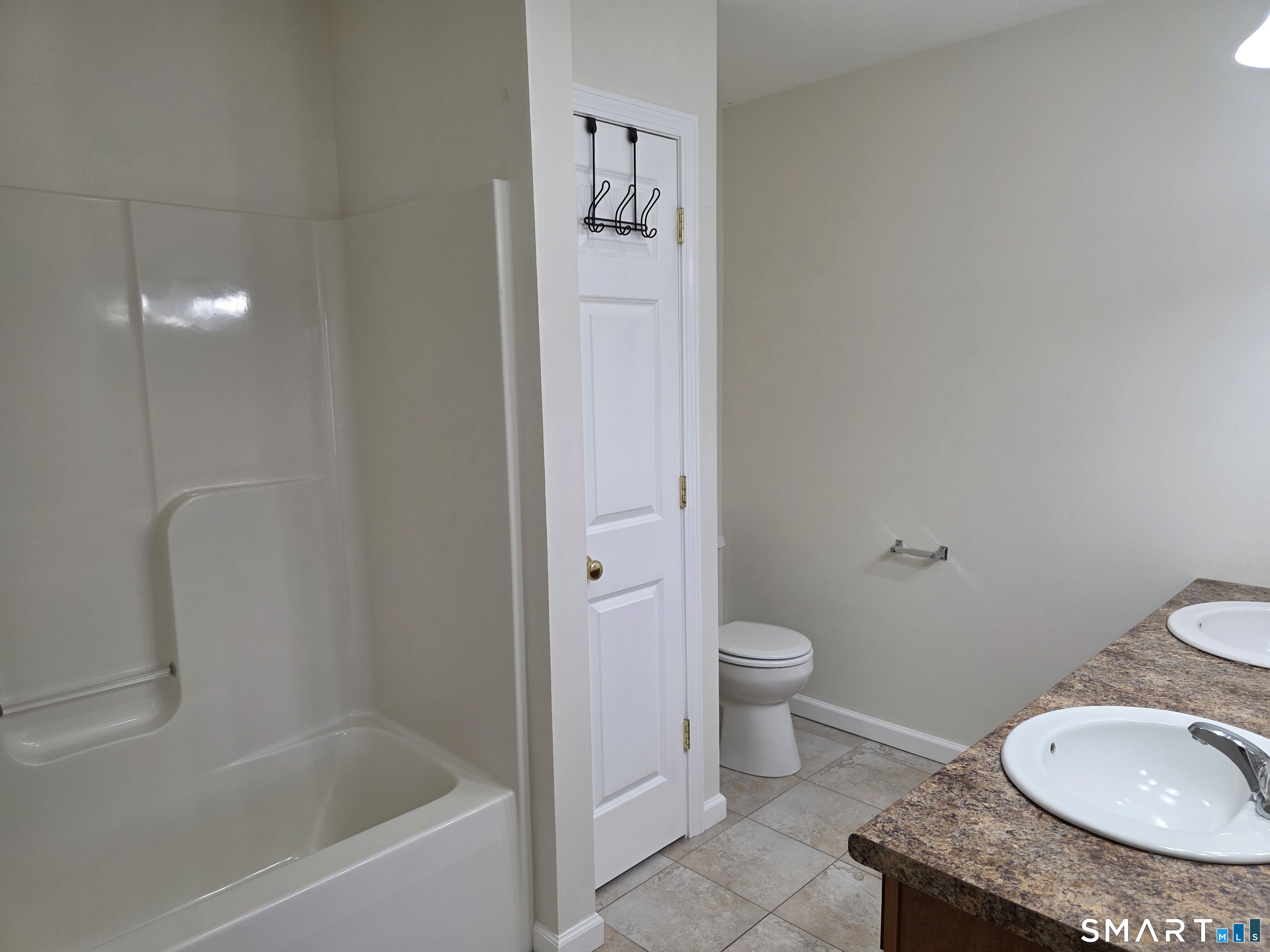 148 Mathewson Street, Unit 609 Griswold, CT 06351 - Photo 23 of 23 a bathroom with a granite countertop toilet and a sink