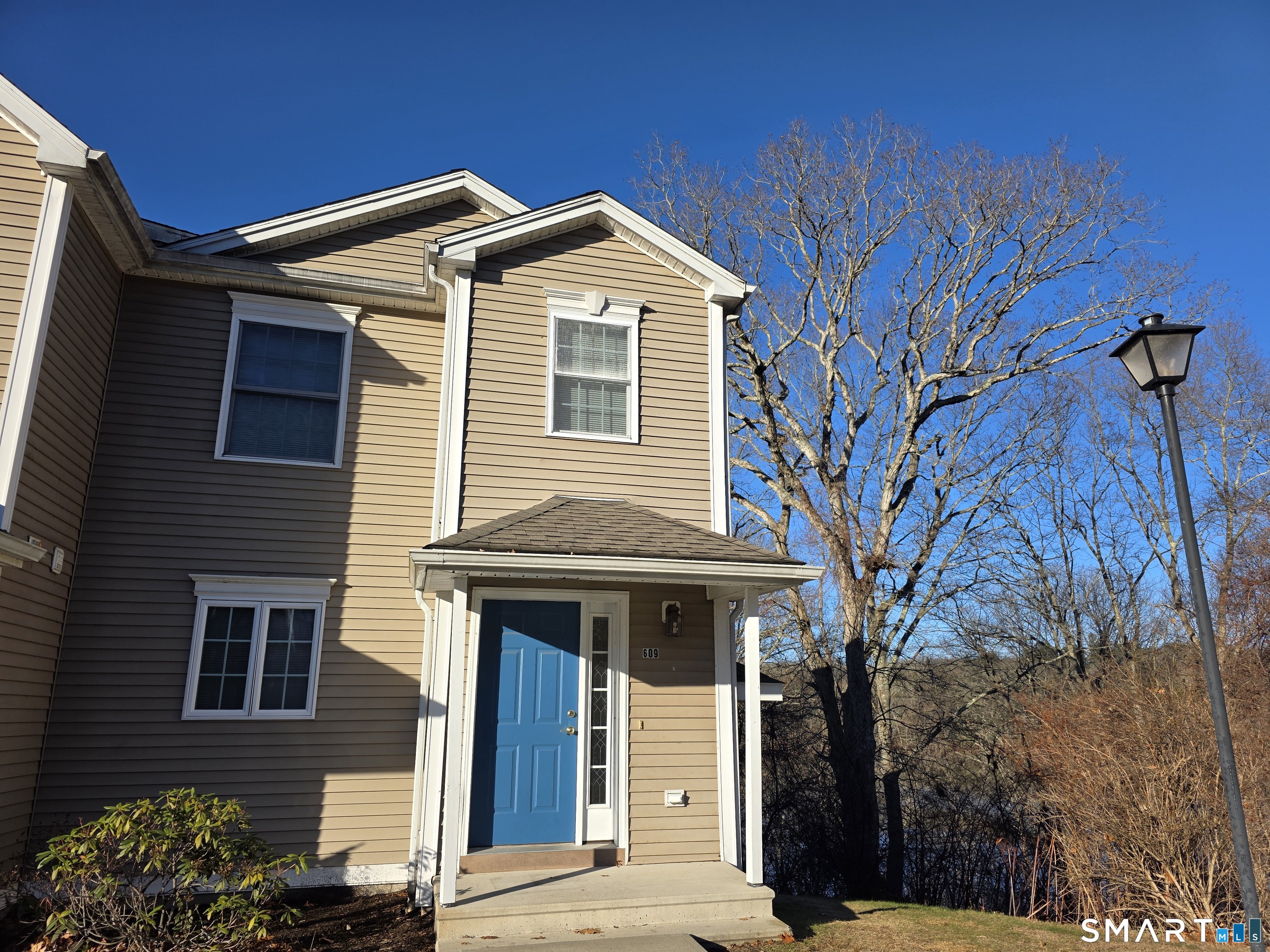 148 Mathewson Street, Unit 609 Griswold, CT 06351 - Photo 3 of 23 a front view of a house with a tree