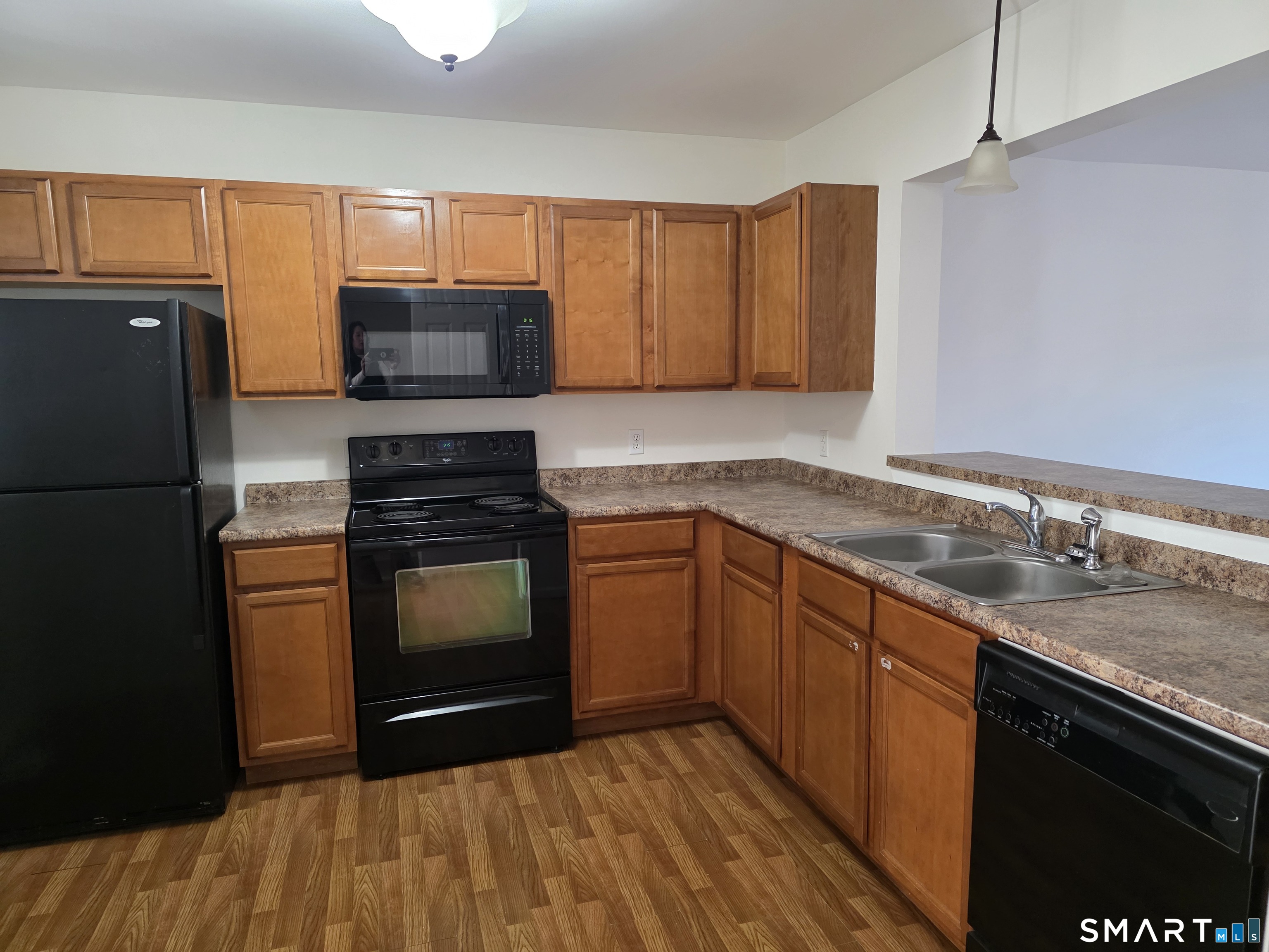 148 Mathewson Street, Unit 609 Griswold, CT 06351 - Photo 4 of 23 a kitchen with granite countertop a refrigerator stove and sink