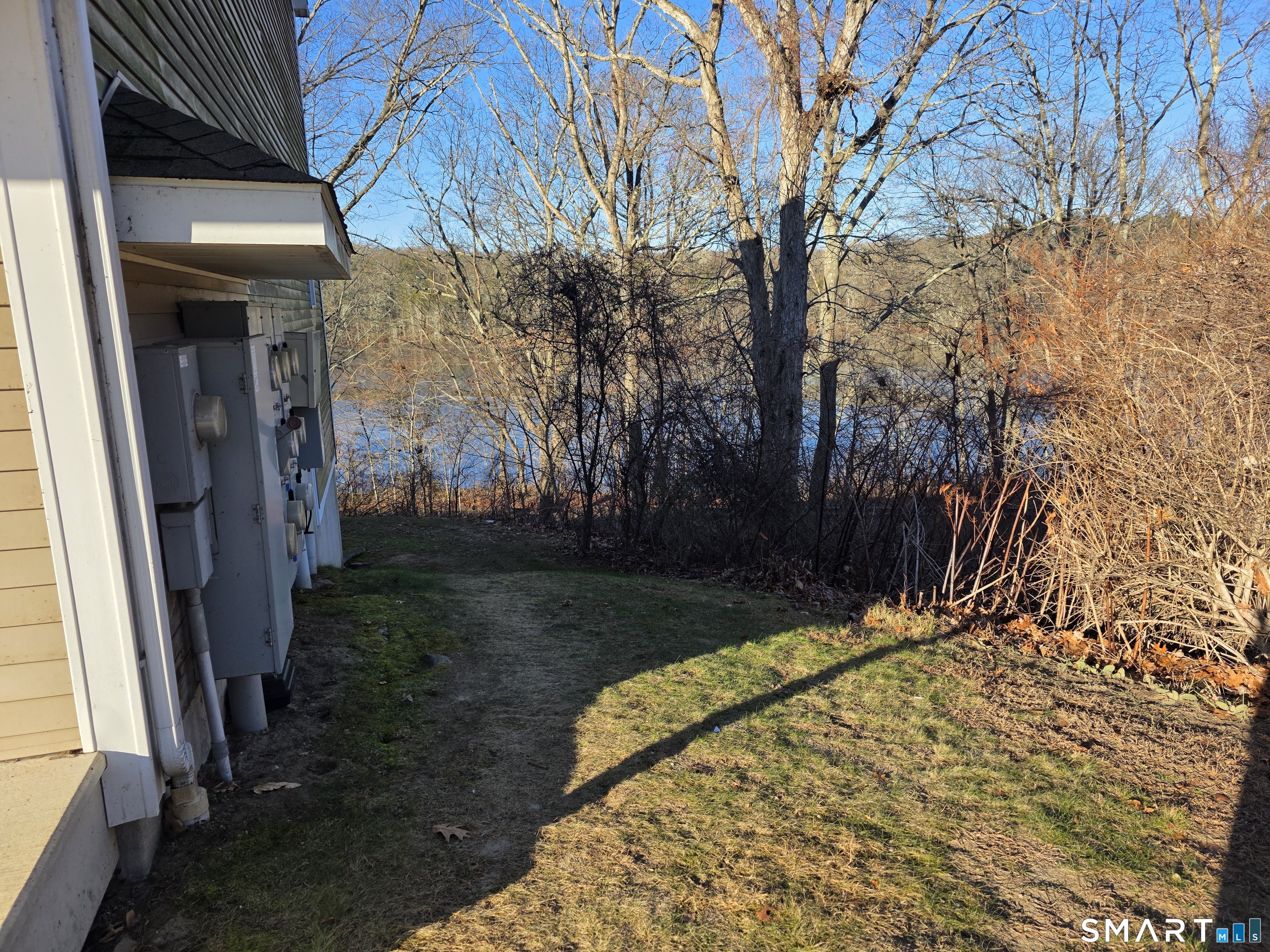148 Mathewson Street, Unit 609 Griswold, CT 06351 - Photo 5 of 23 a view of backyard with patio