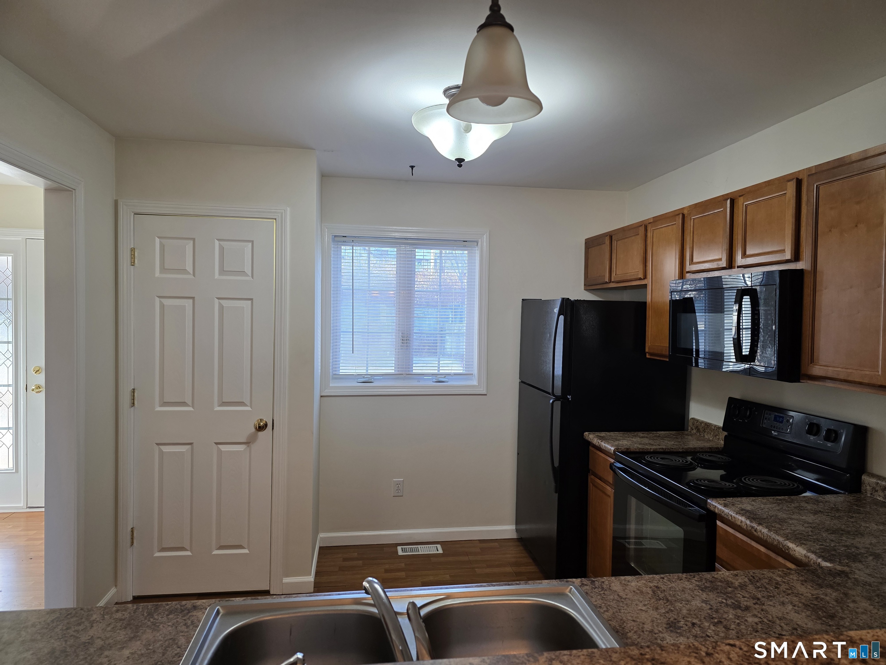 148 Mathewson Street, Unit 609 Griswold, CT 06351 - Photo 6 of 23 a kitchen with a refrigerator and a stove top oven