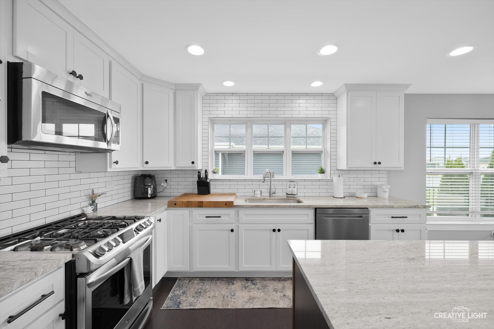 618 Peacock Place Manteno, IL 60950 - Photo 15 of 31 a large kitchen with stainless steel appliances granite countertop a stove a sink dishwasher and a microwave oven with wooden cabinets