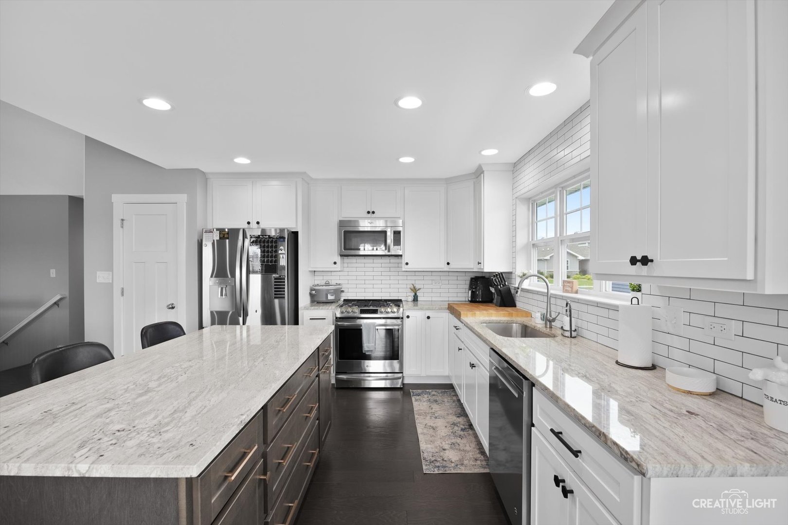 618 Peacock Place Manteno, IL 60950 - Photo 16 of 31 a large kitchen with stainless steel appliances lots of counter space and wooden floor