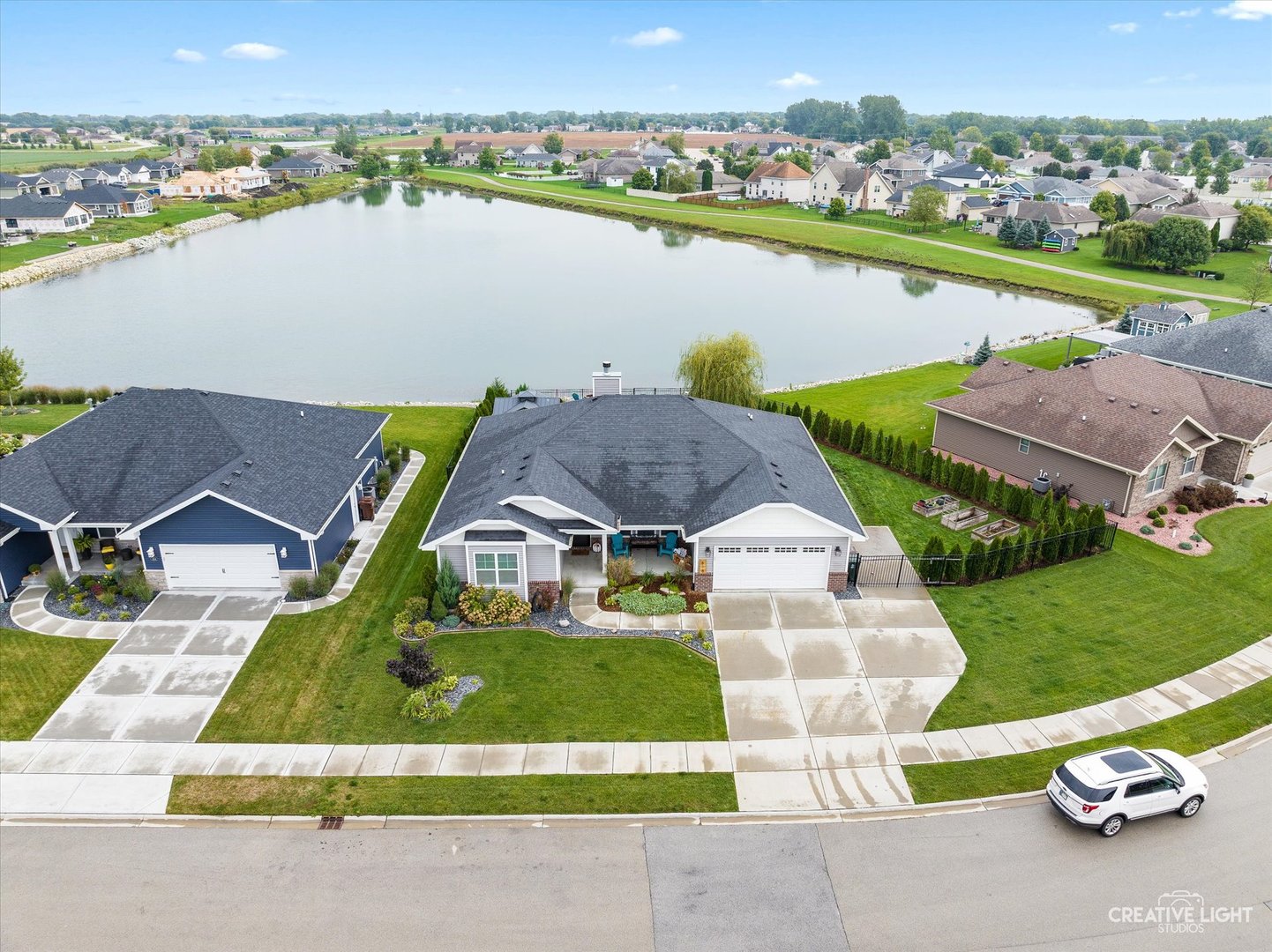618 Peacock Place Manteno, IL 60950 - Photo 2 of 31 an aerial view of a house with a garden and lake view