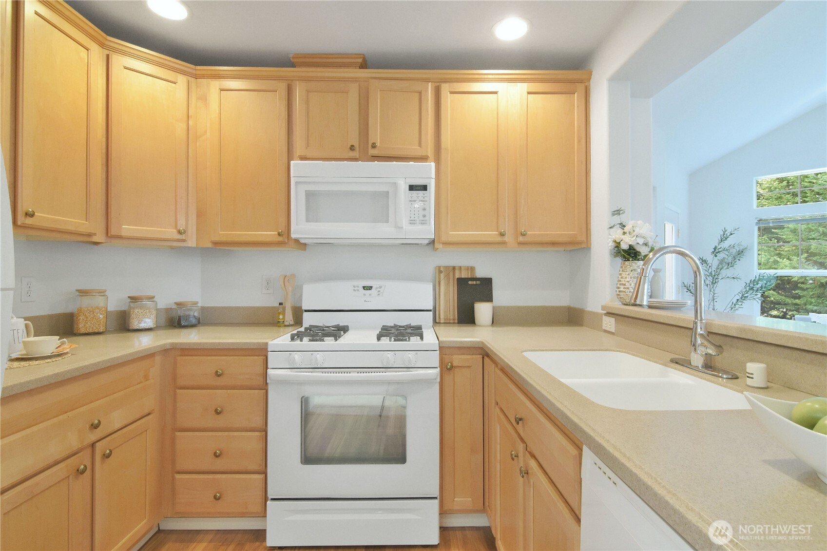 8500 Main Street, Unit F313 Edmonds, WA 98026 - Photo 11 of 24 a kitchen with a sink stove and cabinets
