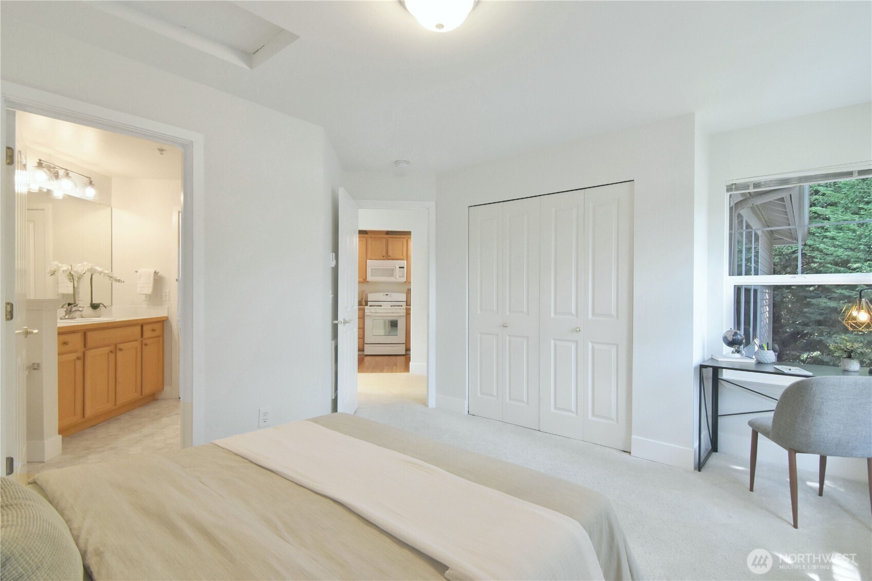 8500 Main Street, Unit F313 Edmonds, WA 98026 - Photo 18 of 24 a bedroom with a bed and a chair