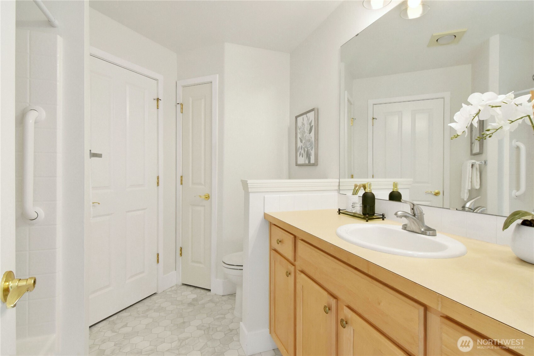8500 Main Street, Unit F313 Edmonds, WA 98026 - Photo 21 of 24 a bathroom with a sink and a mirror