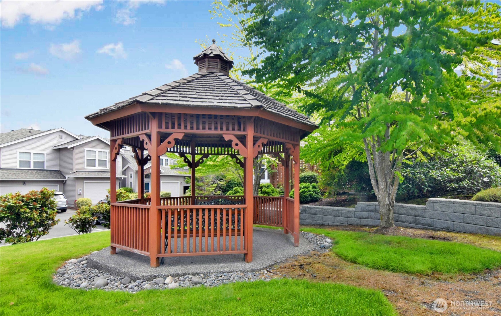 8500 Main Street, Unit F313 Edmonds, WA 98026 - Photo 24 of 24 a view of a deck with a table and chairs with wooden fence