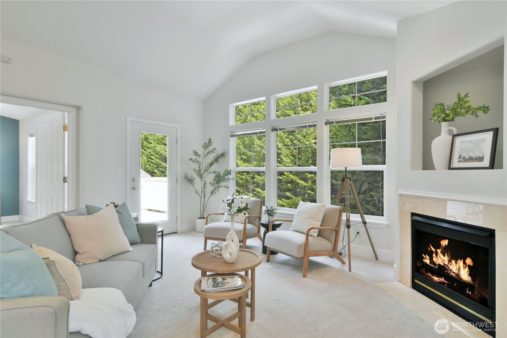 8500 Main Street, Unit F313 Edmonds, WA 98026 - Photo 4 of 24 a living room with furniture a fireplace and a large window