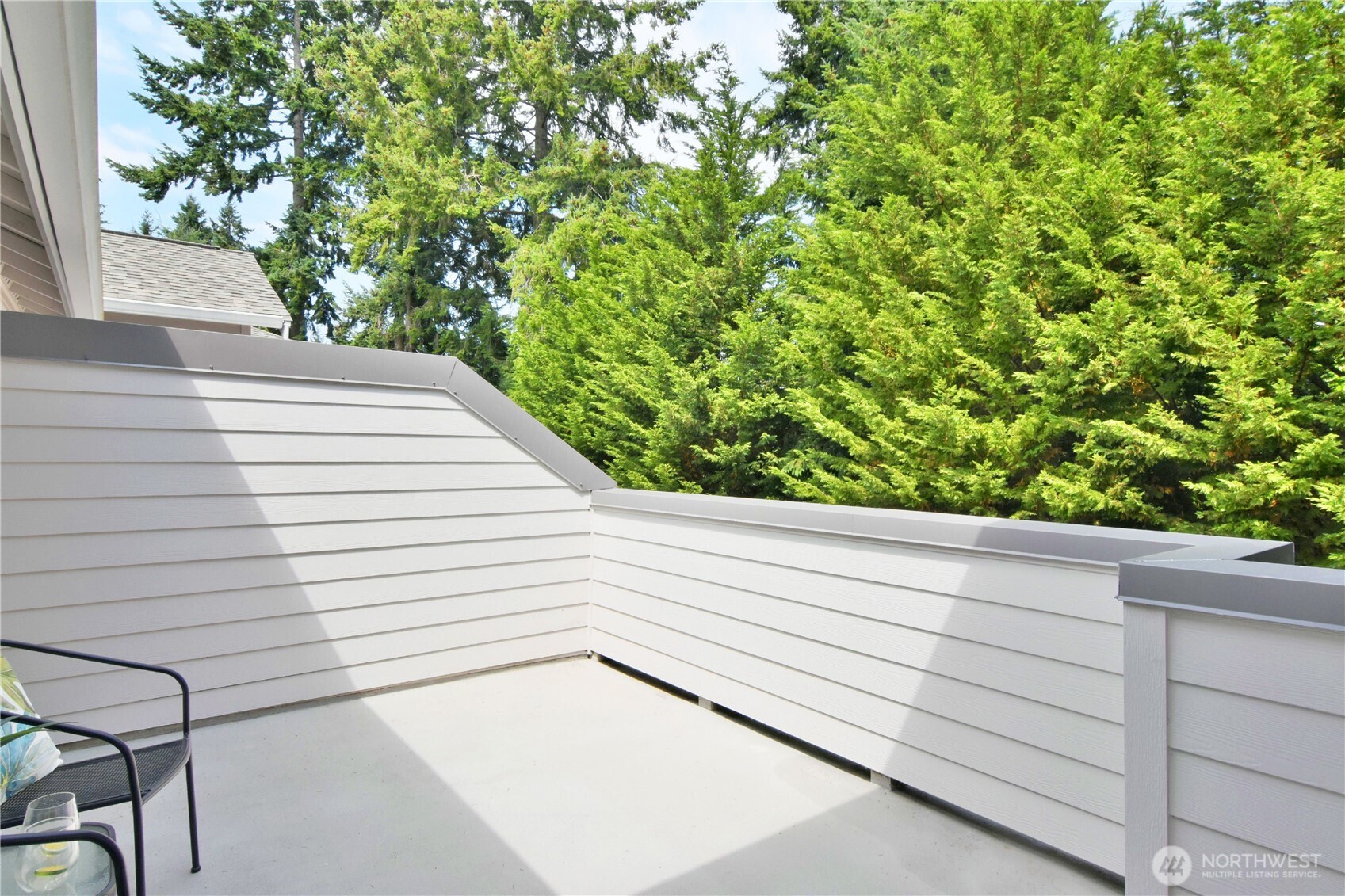 8500 Main Street, Unit F313 Edmonds, WA 98026 - Photo 5 of 24 a view of a terrace that has white walls