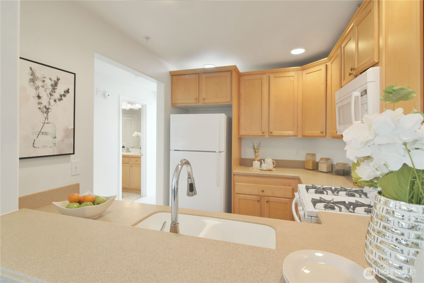 8500 Main Street, Unit F313 Edmonds, WA 98026 - Photo 10 of 24 a kitchen with a sink a stove and refrigerator