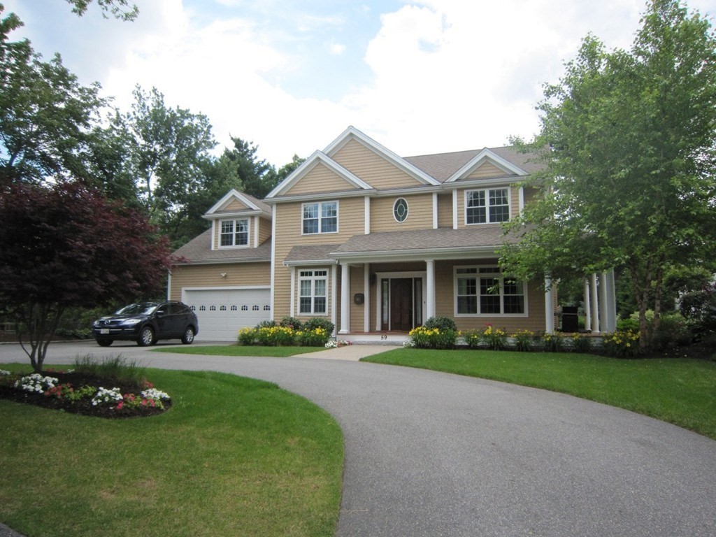 59 Gilman Road Waltham, MA 02452 - Photo 1 of 1 a front view of a house with a garden and trees
