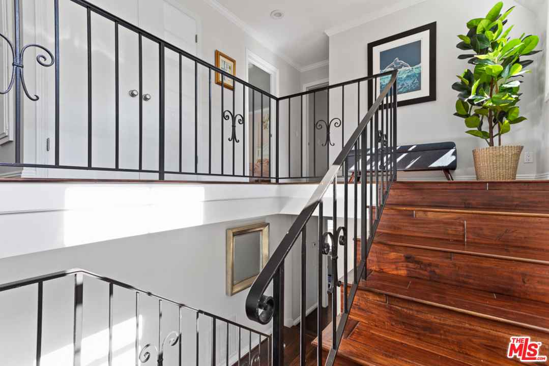 70 Club Road Pasadena, CA 91105 - Photo 15 of 38 a view of staircase with lots of frames on wall and a potted plant