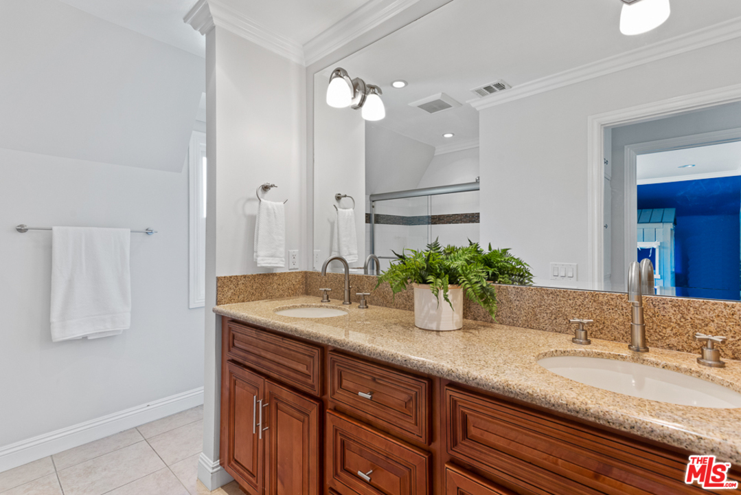 70 Club Road Pasadena, CA 91105 - Photo 19 of 38 a bathroom with a granite countertop sink and a mirror
