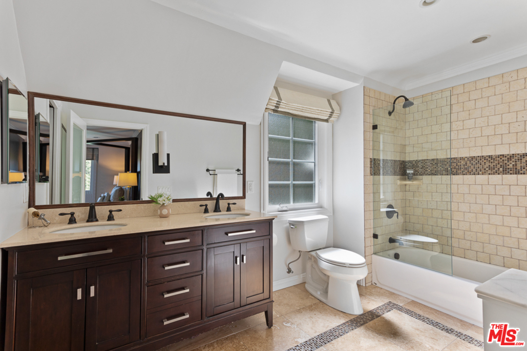 70 Club Road Pasadena, CA 91105 - Photo 23 of 38 a bathroom with a double vanity sink toilet mirror and bathtub