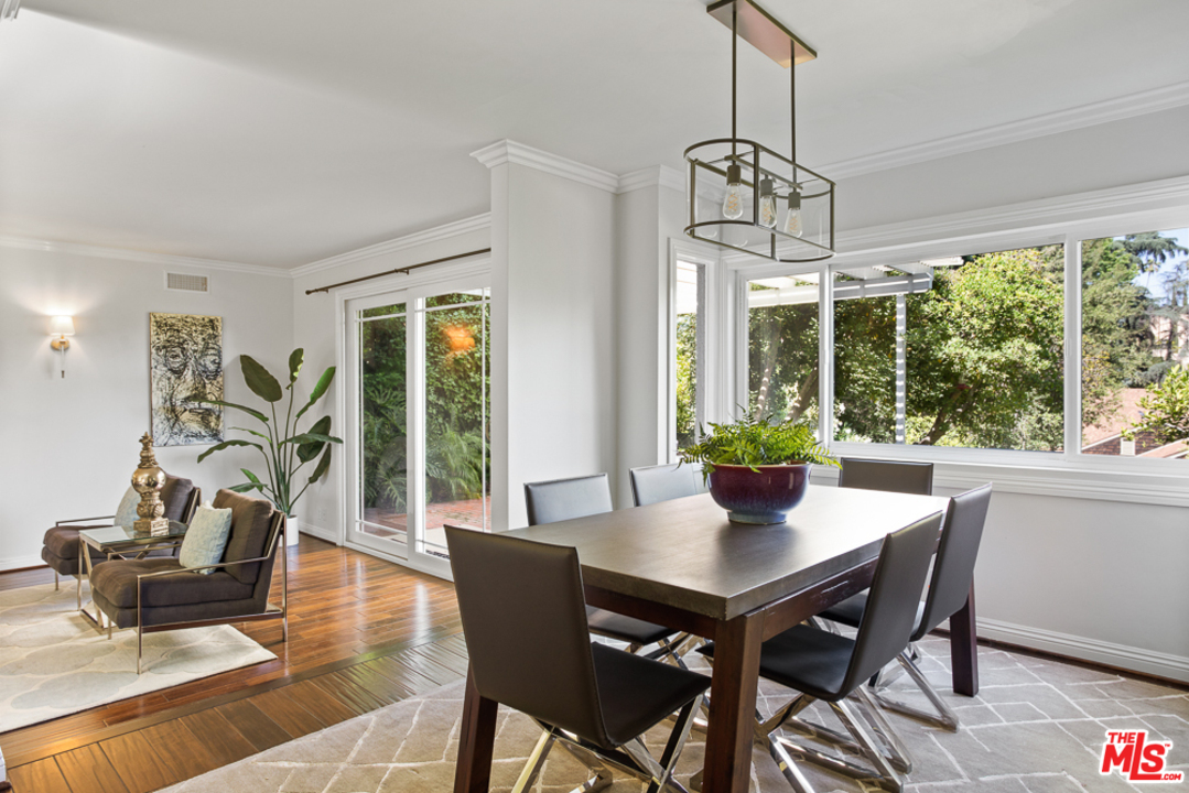 70 Club Road Pasadena, CA 91105 - Photo 5 of 38 a dining room with furniture wooden floor a chandelier and a rug