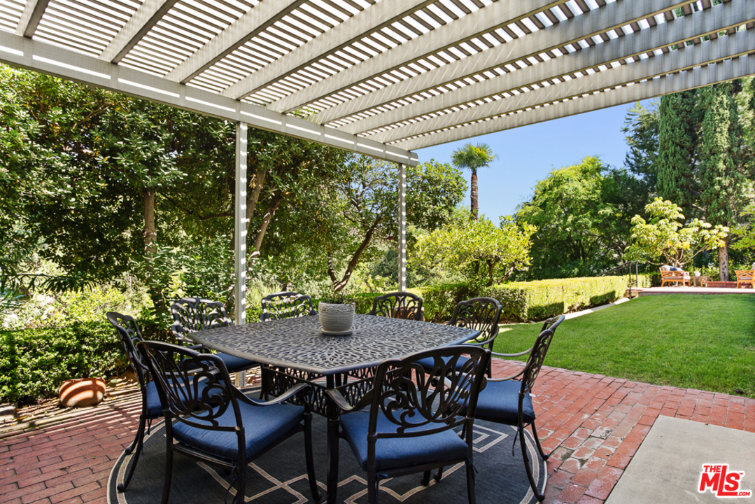 70 Club Road Pasadena, CA 91105 - Photo 6 of 38 a patio with a table and chairs and potted plants