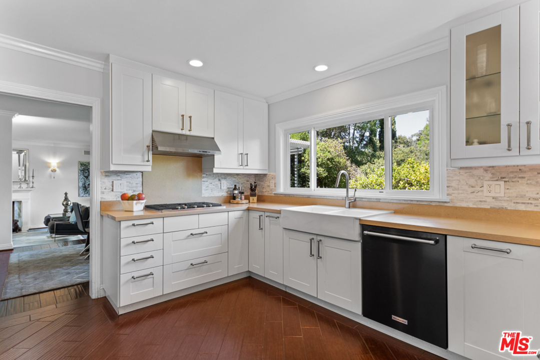 70 Club Road Pasadena, CA 91105 - Photo 9 of 38 a kitchen that has a sink and a stove in it