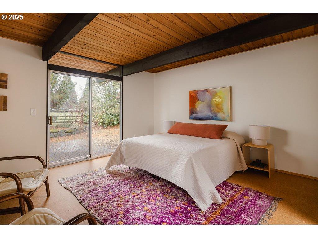 2720 Northwest Forest Avenue Beaverton, OR 97006 - Photo 22 of 40 a bedroom with a bed lamp and a large window