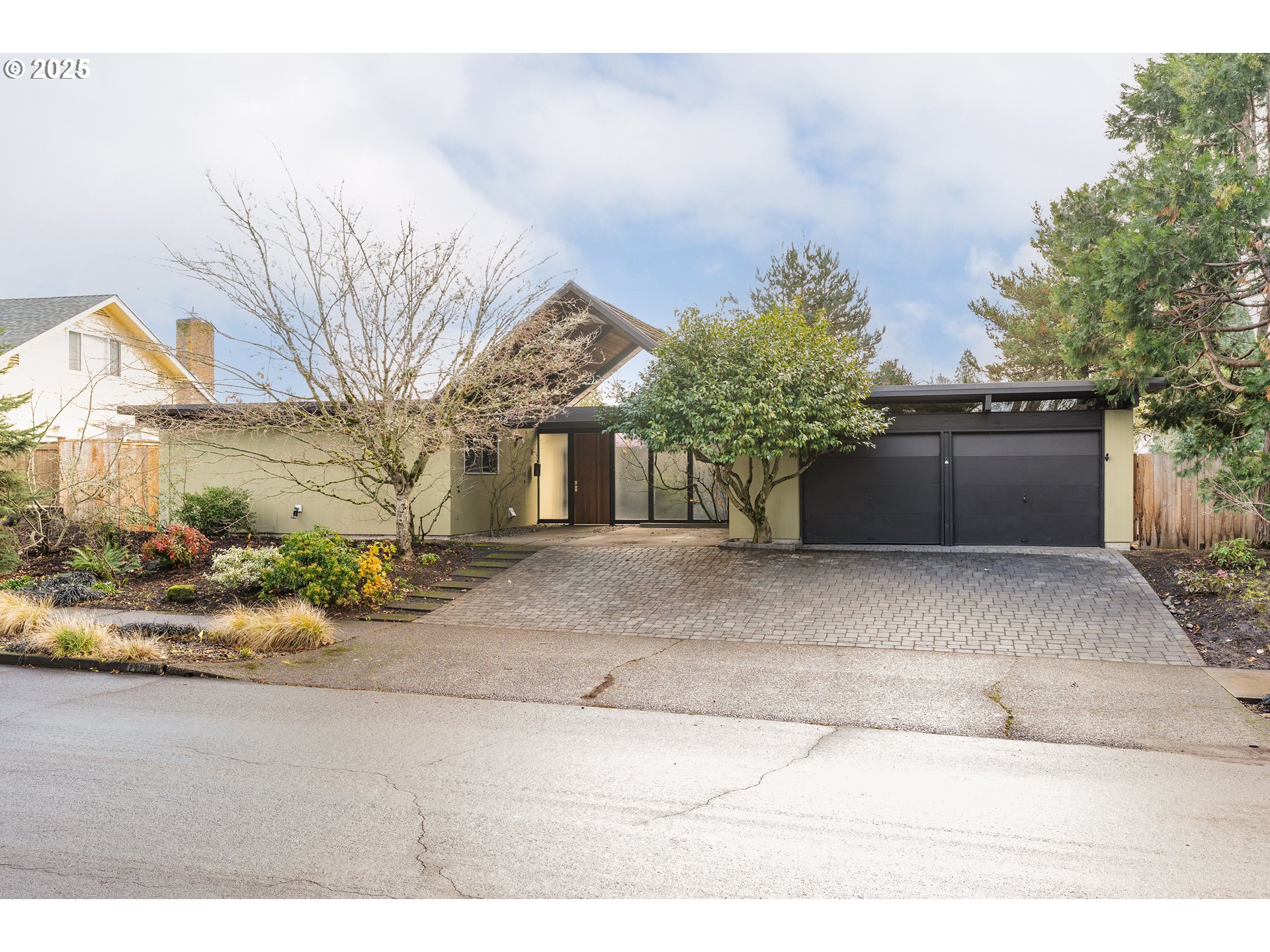 2720 Northwest Forest Avenue Beaverton, OR 97006 - Photo 37 of 40 a front view of a house with a yard and garage