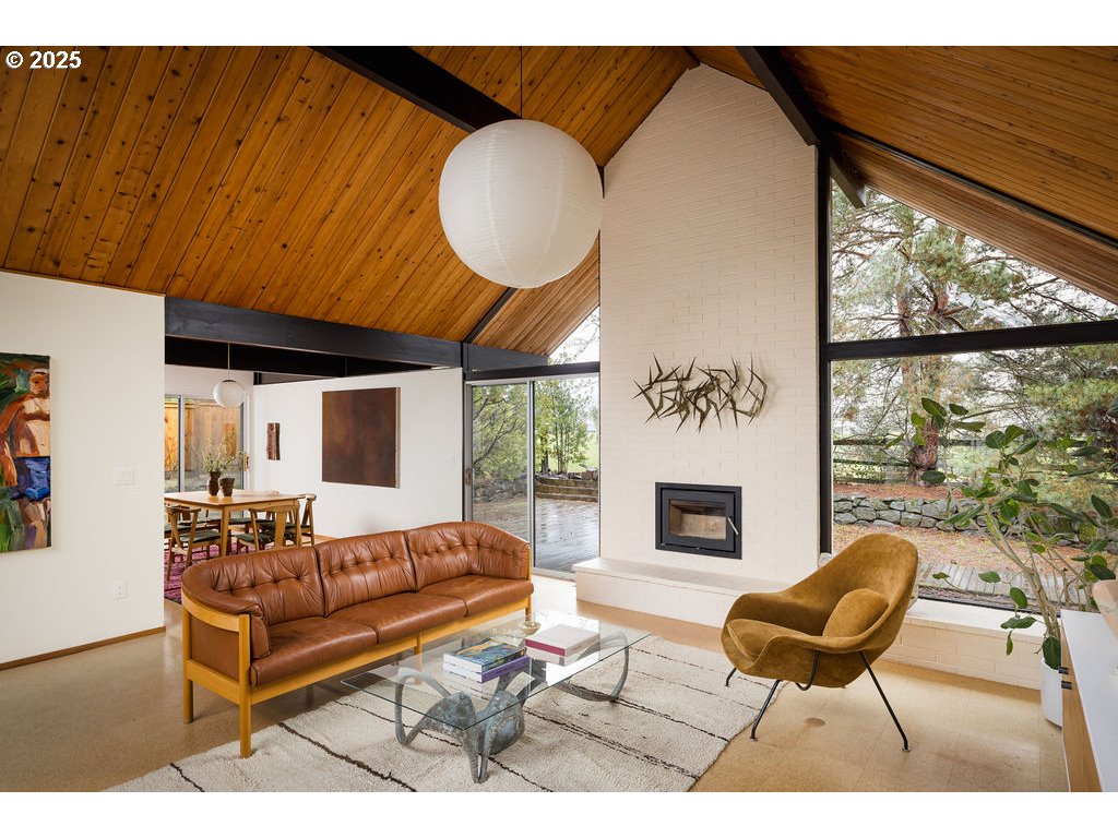 2720 Northwest Forest Avenue Beaverton, OR 97006 - Photo 7 of 40 a living room with furniture a fireplace and a large window