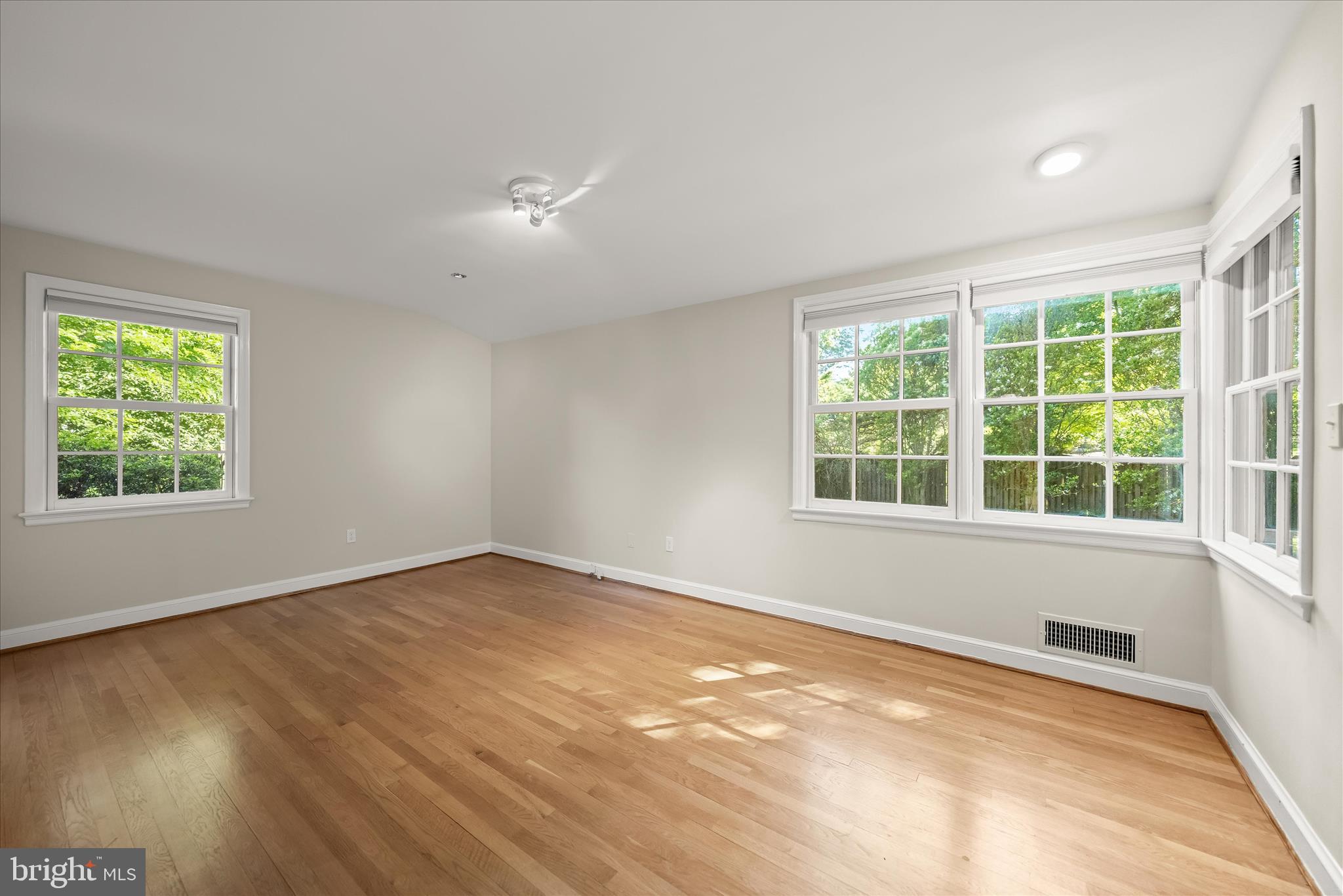 5104 Scarsdale Road Bethesda, MD 20816 - Photo 24 of 68 an empty room with wooden floor and windows