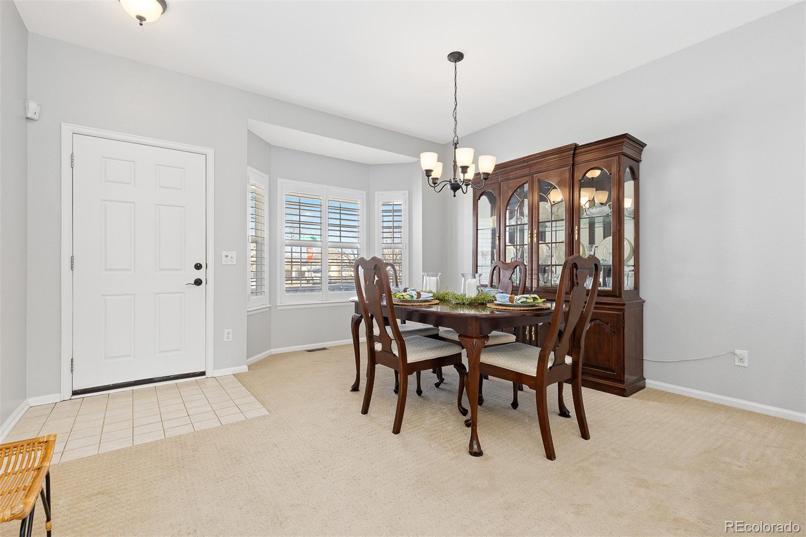 9810 Mulberry Way Highlands Ranch, CO 80129 - Photo 11 of 49 a view of a dining room with furniture and chandelier